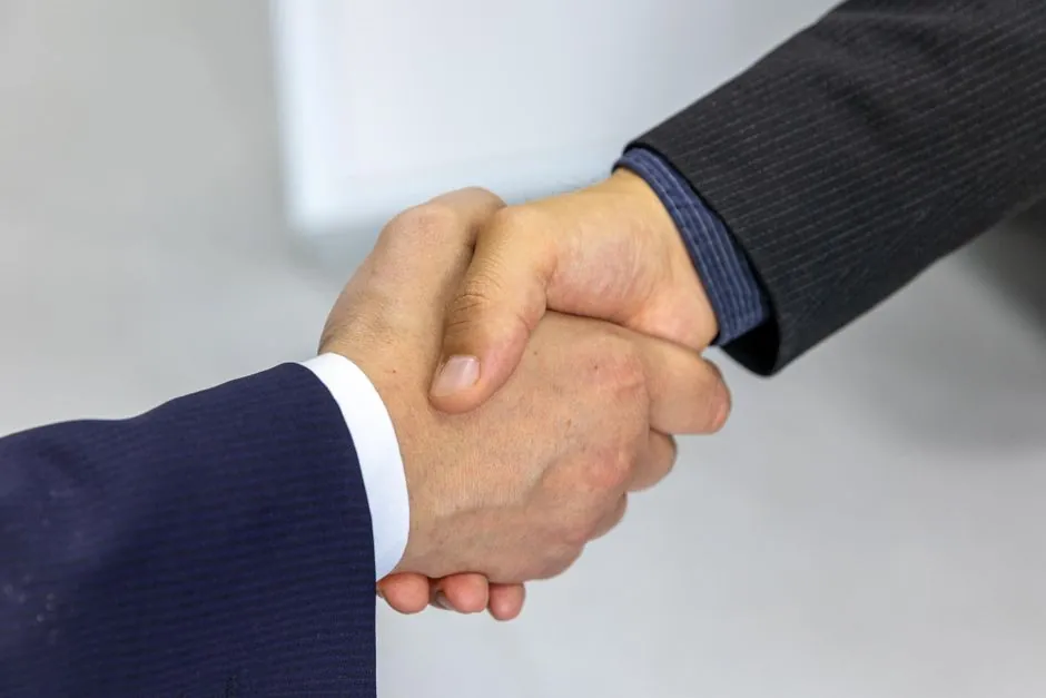 Business handshake representing a trusted, defensible decision
