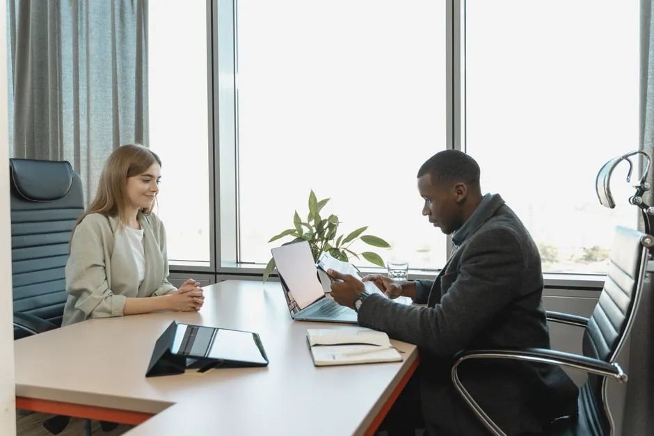 HR professional reviewing candidate applications on a laptop