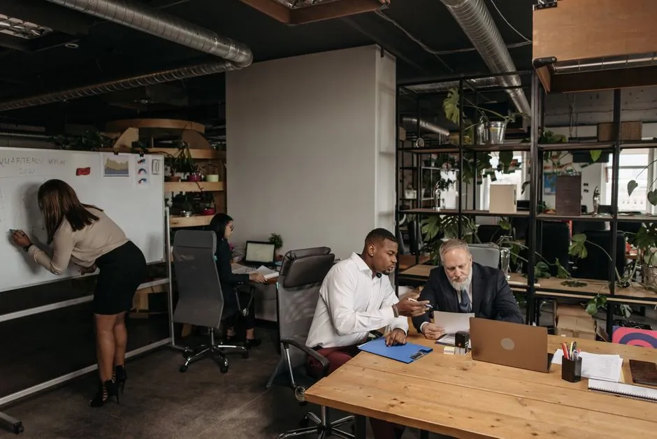 Large open-plan office with many employees at workstations