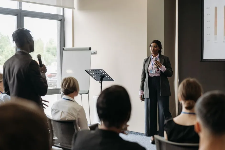 Person speaking during a business presentation in a meeting room