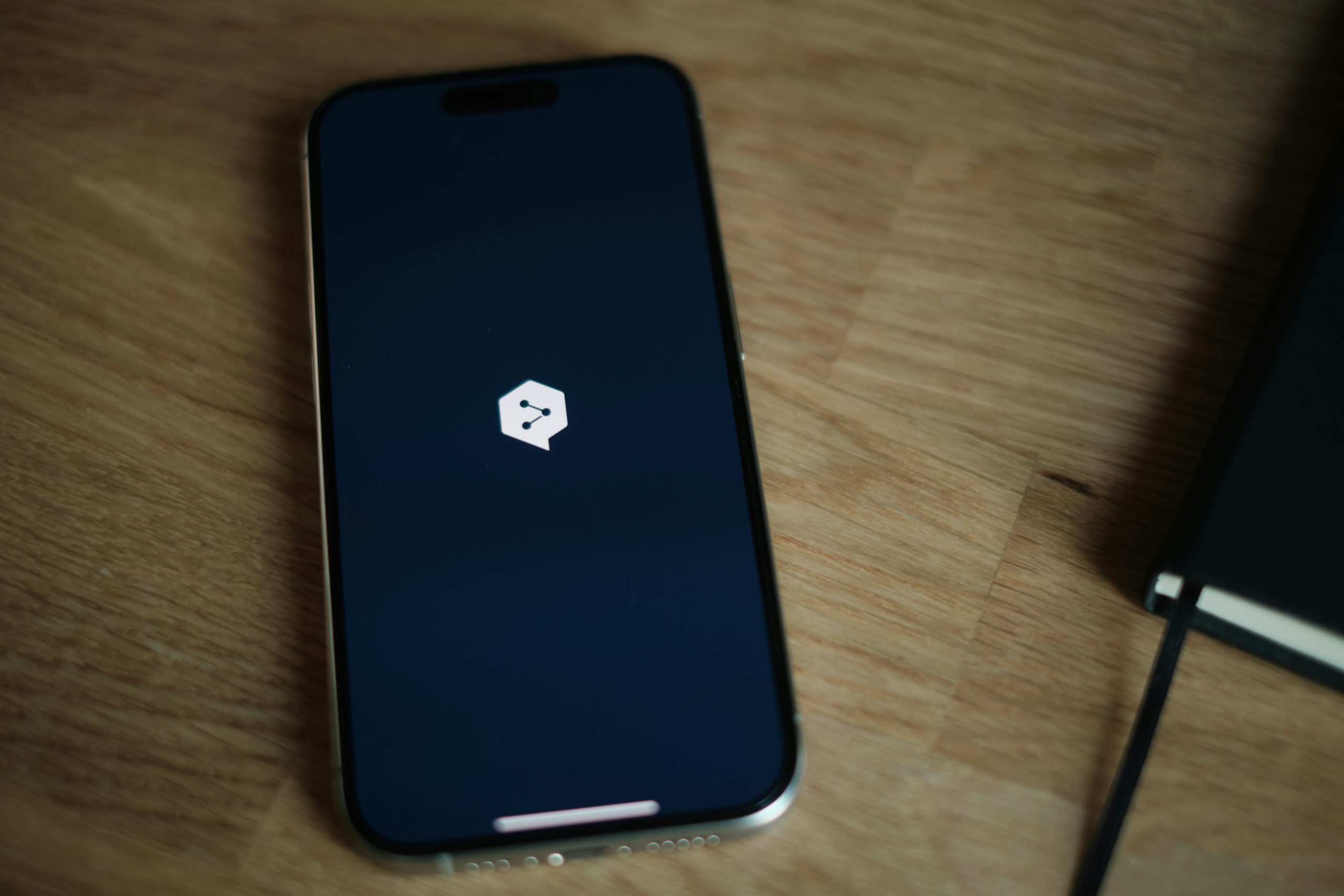 A cell phone sitting on top of a wooden table